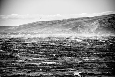 Scenic view of sea and landscape against sky