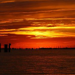 Scenic view of sea against orange sky