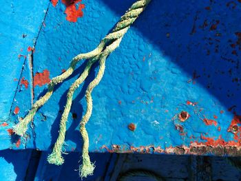 Close-up of rope against blue wall