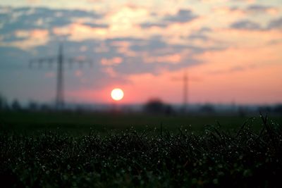 Scenic view of field against sky during sunset