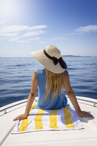 Rear view of woman looking at sea against sky