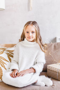 Portrait of a girl sitting on bed