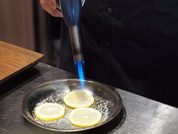 Close-up of person preparing food on table