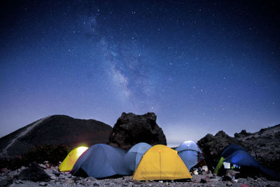 Tents against sky at night