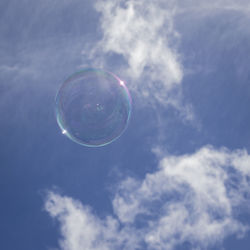 Low angle view of bubbles against sky