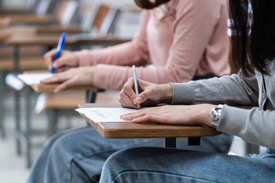 Midsection of couple holding book