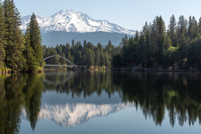 Mount shasta reflection with an arched bridge in the foreground