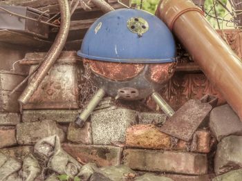 High angle view of rusty toys on stone wall