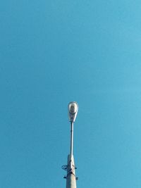 Low angle view of street light against blue sky