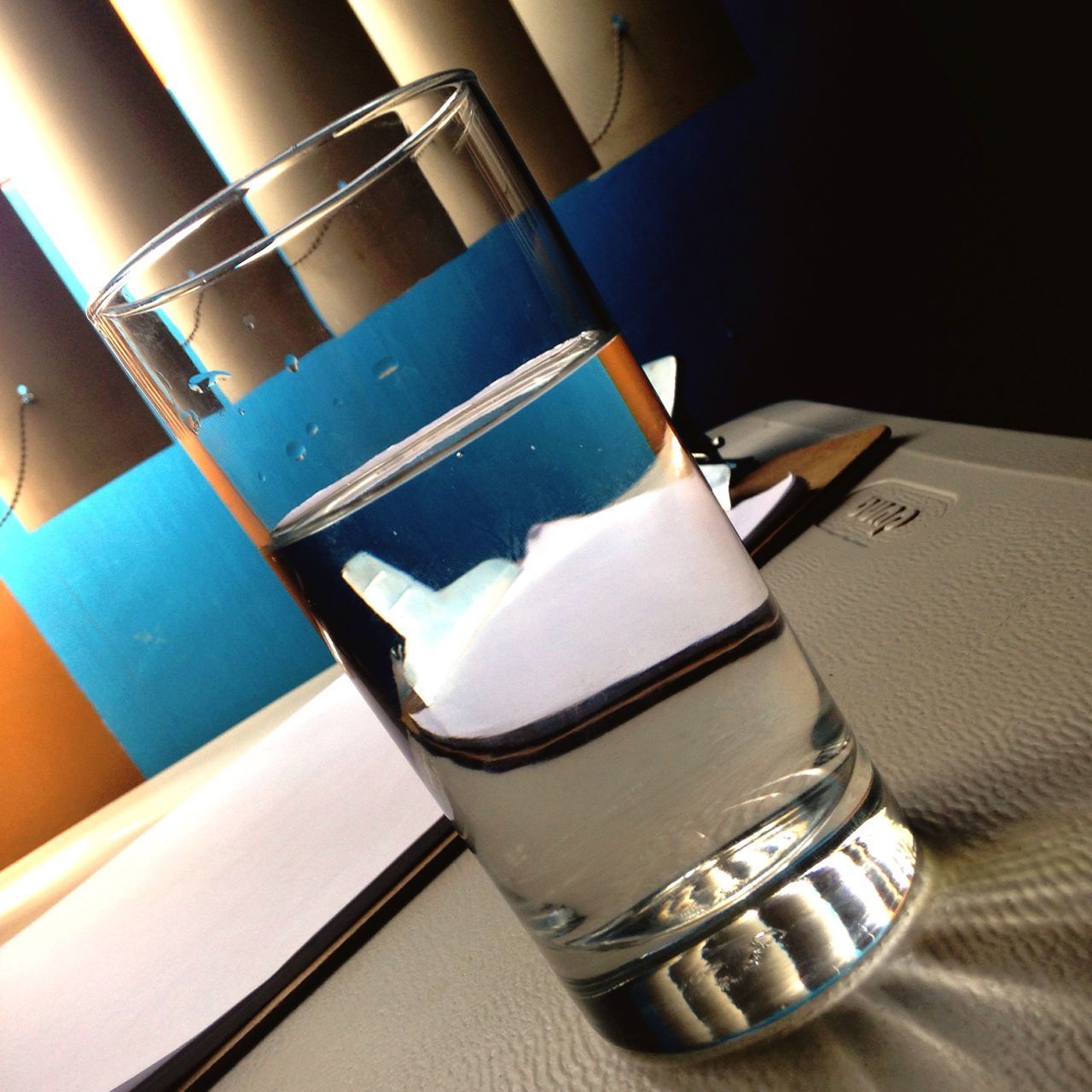 indoors, still life, close-up, table, no people, focus on foreground, absence, white color, metal, blue, empty, day, sunlight, high angle view, chair, drink, reflection, book, part of, single object