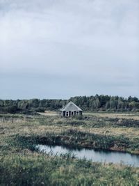 Scenic view of landscape and houses against sky