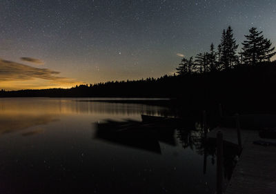 Scenic view of lake against sky at night