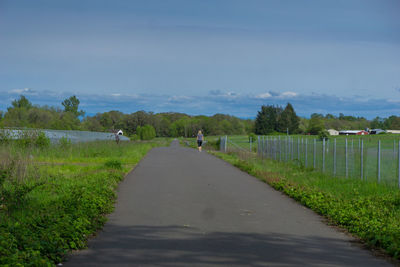 Empty road passing through field