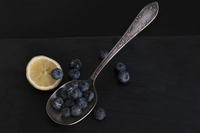 High angle view of fruits on table against black background
