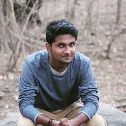 Portrait of young man sitting outdoors