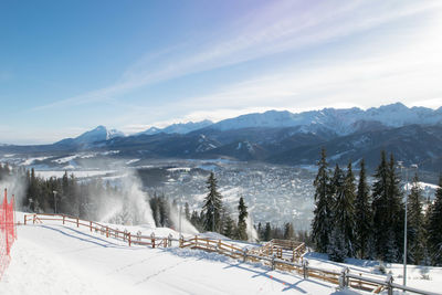Scenic view of snow covered mountains against sky