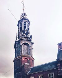 Low angle view of bell tower against sky