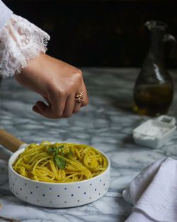 Cropped hand of person preparing food