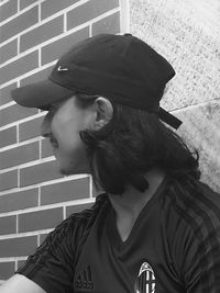 Portrait of teenage girl looking away against wall