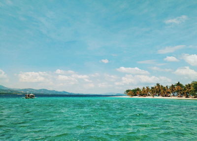 Scenic view of sea against cloudy sky