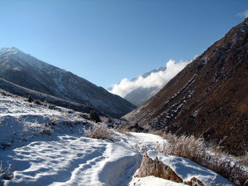 Scenic view of mountains against blue sky