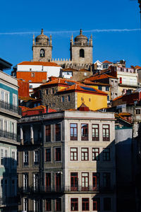 Buildings in town against blue sky