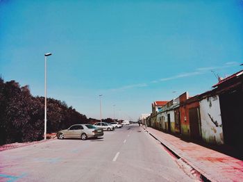 Cars on road against clear sky