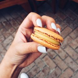 Close-up of hand holding biscuit