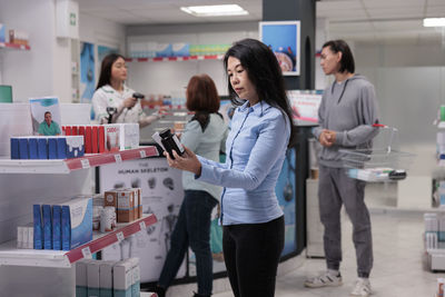 Portrait of young woman standing in laboratory