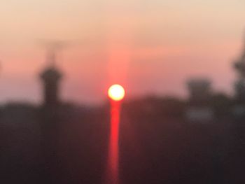 Close-up of illuminated city at sunset