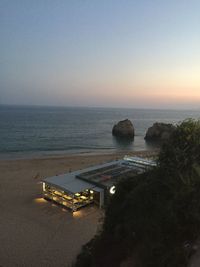 High angle view of sea against clear sky during sunset