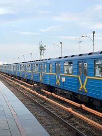 Train at railroad station against sky