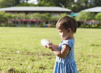 Little girl staring at a light bulb,concept light of wisdom,great idea.