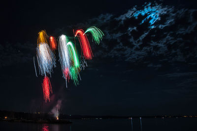 Low angle view of firework display against sky at night