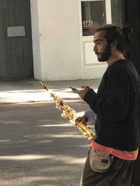 Side view of man playing guitar at music concert