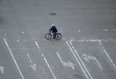 Man riding bicycle on road