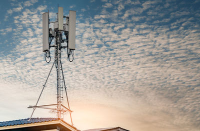 Low angle view of communications tower against sky