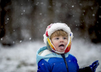 Portrait of cute girl standing in snow