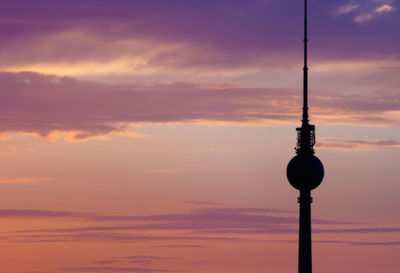 Low angle view of silhouette tower against sky during sunset