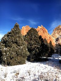 Snow on rock against sky