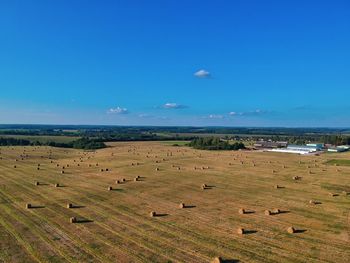 Scenic view of field against blue sky