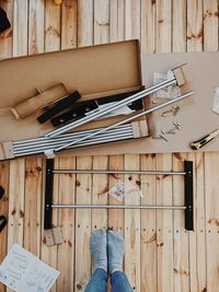 Low section of man standing on wooden floor
