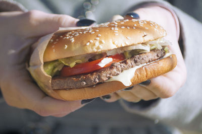 Close-up of hand holding burger