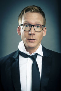 Portrait of young man wearing eyeglasses against black background