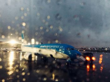 View of airport seen through airplane window