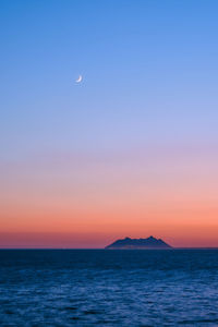 Scenic view of sea against clear sky during sunset