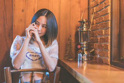 Close-up of young woman sitting at cafe