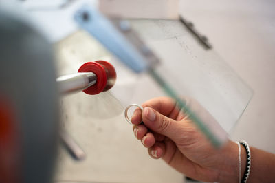 Cropped hand of making wedding ring in workshop