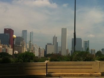 Skyscrapers against cloudy sky