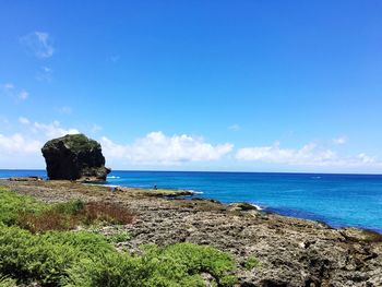 Scenic view of beach against blue sky